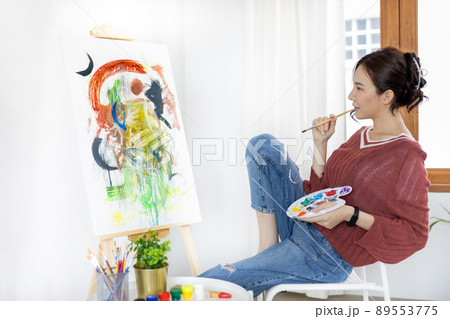 Female artist painting on canvas, Artist studio interior, Draw with watercolor, Drawing supplies , Painting and creativity, Use a brush to draw a pattern by stripes, Artwork, Using Paint Brush. Female artist painting on canvas, Artist studio interior, Draw with watercolor, Drawing supplies , Painting and creativity, Use a brush to draw a pattern by stripes, Artwork, Using Paint Brush. 89553775
