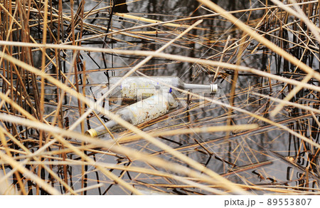 garbage in the water, used glass bottle in the pound garbage in the water, used glass bottle in the pound 89553807