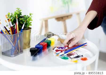 Female artist painting on canvas, Artist studio interior, Draw with watercolor, Drawing supplies , Painting and creativity, Use a brush to draw a pattern by stripes, Artwork, Using Paint Brush. Female artist painting on canvas, Artist studio interior, Draw with watercolor, Drawing supplies , Painting and creativity, Use a brush to draw a pattern by stripes, Artwork, Using Paint Brush. 89553815