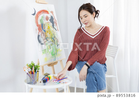 Female artist painting on canvas, Artist studio interior, Draw with watercolor, Drawing supplies , Painting and creativity, Use a brush to draw a pattern by stripes, Artwork, Using Paint Brush. Female artist painting on canvas, Artist studio interior, Draw with watercolor, Drawing supplies , Painting and creativity, Use a brush to draw a pattern by stripes, Artwork, Using Paint Brush. 89553816