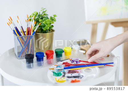 Female artist painting on canvas, Artist studio interior, Draw with watercolor, Drawing supplies , Painting and creativity, Use a brush to draw a pattern by stripes, Artwork, Using Paint Brush. 89553817