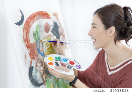 Female artist painting on canvas, Artist studio interior, Draw with watercolor, Drawing supplies , Painting and creativity, Use a brush to draw a pattern by stripes, Artwork, Using Paint Brush. Female artist painting on canvas, Artist studio interior, Draw with watercolor, Drawing supplies , Painting and creativity, Use a brush to draw a pattern by stripes, Artwork, Using Paint Brush. 89553818