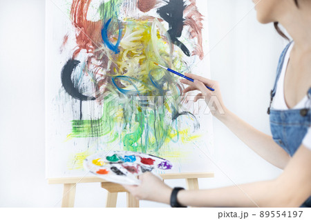 Female artist painting on canvas, Artist studio interior, Draw with watercolor, Drawing supplies , Painting and creativity, Use a brush to draw a pattern by stripes, Artwork, Using Paint Brush. 89554197