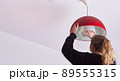 unrecognizable blonde woman changing a light bulb at home, DIY. 89555315