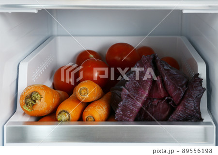 Open refrigerator full of fresh vegetables, closeup 89556198