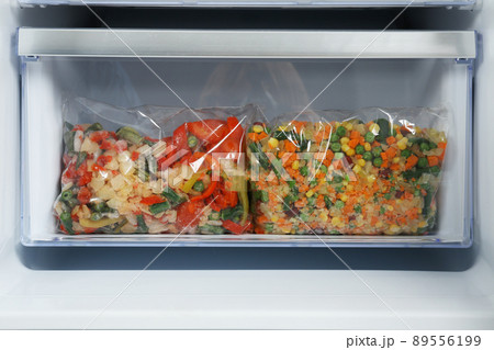 Bags with frozen vegetables in modern refrigerator 89556199