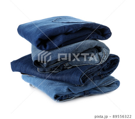 Stack of different jeans isolated on white Stack of different jeans isolated on white 89556322