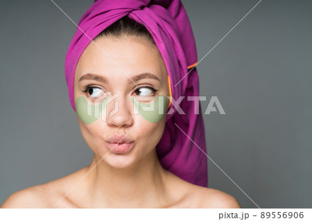 with a towel wrapped around her head with nude shoulders pasted patches under her eyes with a towel wrapped around her head with nude shoulders pasted patches under her eyes 89556906