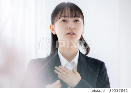 就活　胸に手を当てて緊張している女性 89557846