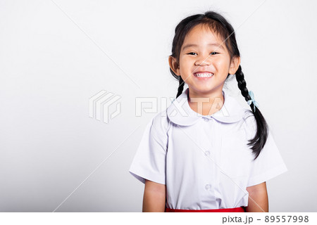 Asian adorable toddler smiling happy wearing student thai uniform standing 89557998