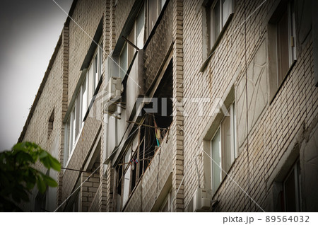 Ukrainian-Russian War 2022. A residential building in Mykolaiv that suffered from Russian army shelling. The balcony of an apartment building without glass. A burned apartment building. Ukrainian-Russian War 2022. A residential building in Mykolaiv that suffered from Russian army shelling. The balcony of an apartment building without glass. A burned apartment building. 89564032