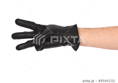 Man wearing black leather glove on white background, closeup. Tree fingers forward. 89564232