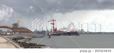 Dutch coast - Steel factory plant with chimneys in the background Dutch coast - Steel factory plant with chimneys in the background 89564849