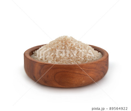 Uncooked Dry Rice in Wooden Bowl on White Background. File with Clipping Path. Uncooked Dry Rice in Wooden Bowl on White Background. File with Clipping Path. 89564922