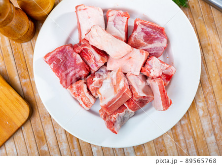 Unprepared pork ribs chopped on table and ready-to-cook 89565768