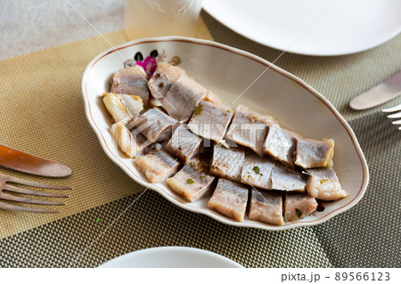 Pieces of pickled herring on a plate Pieces of pickled herring on a plate 89566123