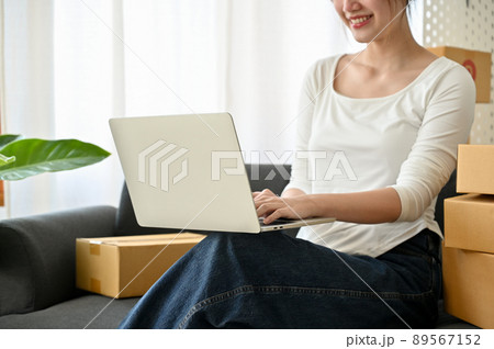 Successful female online business entrepreneur working on laptop computer Successful female online business entrepreneur working on laptop computer 89567152