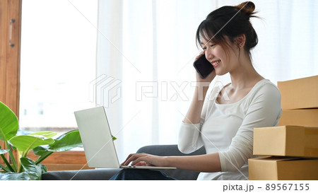 Female business startup entrepreneur talking on the phone with her supplier Female business startup entrepreneur talking on the phone with her supplier 89567155