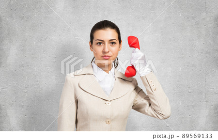 Beautiful business woman with vintage red phone 89569133