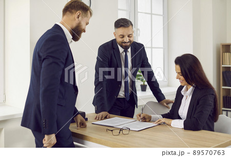 Business people at meeting in office sign contract confirming partnership agreement. Business people at meeting in office sign contract confirming partnership agreement. 89570763
