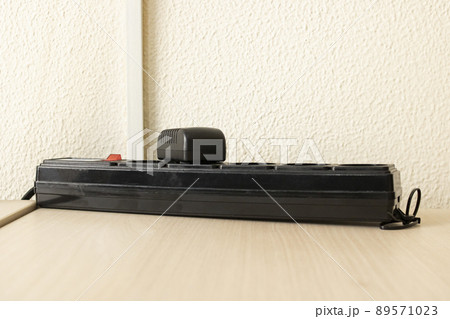 Power supply for various devices on wooden table 89571023