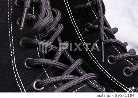Pair of womens black boots on gray background 89571184