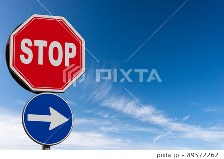 Stop and One Way Road Sign against a Clear Blue...の写真素材