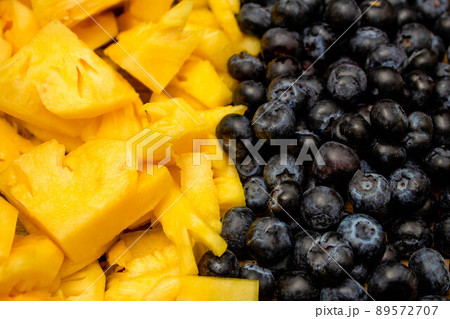 Fresh fruits background, Tropical fruit and berries are consisted of slice pineapple and blueberry Fresh fruits background, Tropical fruit and berries are consisted of slice pineapple and blueberry 89572707