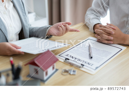 Insurance concept the broker explaining the agreement of the contract to his customer Insurance concept the broker explaining the agreement of the contract to his customer 89572743