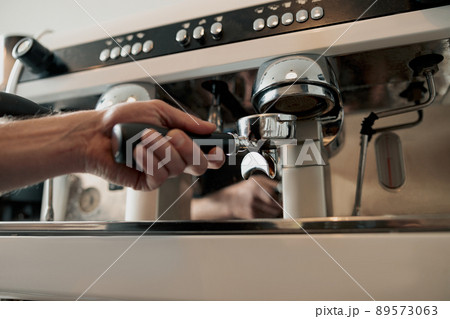 Process of pouring ground coffee into the filter Process of pouring ground coffee into the filter 89573063