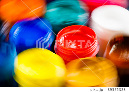 full-frame close-up view of opened gouache paint jars with natural motion blur full-frame close-up view of opened gouache paint jars with natural motion blur 89575323