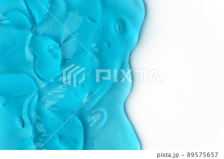 Texture of transparent antiseptic gel with air bubbles on white background. Concept of skin moisturizing, cosmetics and prevention of virus. Liquid beauty product closeup. Backdrop, flat lay 89575657