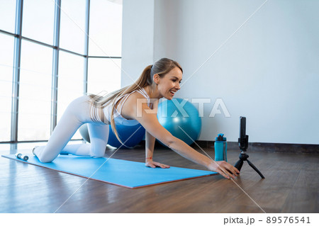 Fitness video blogger starts recording video on smartphone Fitness video blogger starts recording video on smartphone 89576541