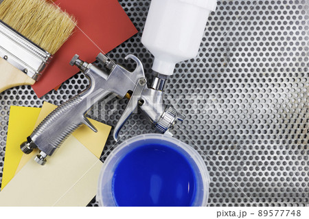 paint spray gun at work at the workplace in the workshop. paint spray gun at work at the workplace in the workshop. 89577748