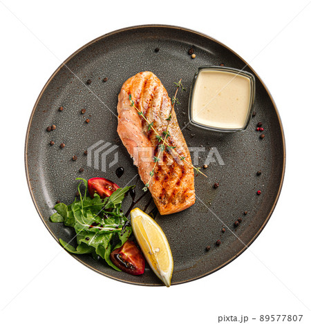 Isolated plate of grilled salmon steak with sauce Isolated plate of grilled salmon steak with sauce 89577807