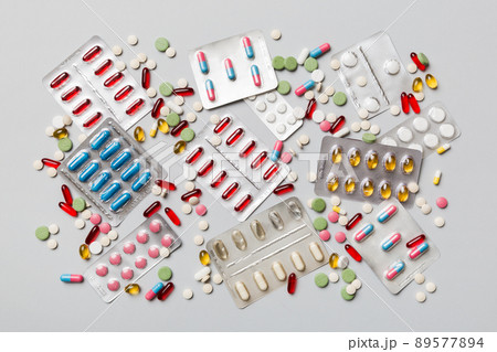Protective face masks or surgical masks, medicine pills and thermometer on table background. Coronavirus disease. Corona virus concept. Space for text 89577894