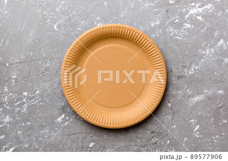 Top view of eco paper plate on cement background. Empty space for your design 89577906