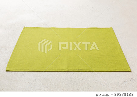 Perspective view of green tablecloth for food on cement background. Empty space for your design 89578138