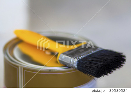 Top view of new shiny clean sealed tin full of red paint and painting brush on it, isolated on white. Tools, materials, building and reconstruction concept. 89580524