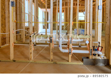 Buildt new home construction featuring hot and cold water PEX plastic plumbing tubes. 89580575