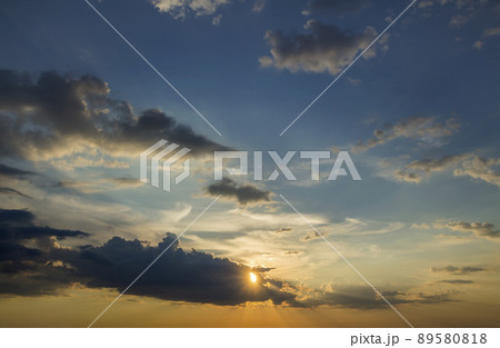 Panorama of sky at sunrise or sunset. Beautiful view of dark blue clouds lit by bright orange yellow sun on clear sky. Beauty and power of nature, meteorology and climate changing concept. Panorama of sky at sunrise or sunset. Beautiful view of dark blue clouds lit by bright orange yellow sun on clear sky. Beauty and power of nature, meteorology and climate changing concept. 89580818