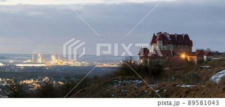 Lonely building castle standing on top of mountain hill and industrial power station oland behind at night. Ivano-Frankivsk city, Ukraine Lonely building castle standing on top of mountain hill and industrial power station oland behind at night. Ivano-Frankivsk city, Ukraine 89581043
