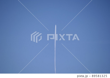 Distant passenger jet plane flying on high altitude on clear blue sky leaving white smoke trace of contrail behind. Air transportation concept. Distant passenger jet plane flying on high altitude on clear blue sky leaving white smoke trace of contrail behind. Air transportation concept. 89581325