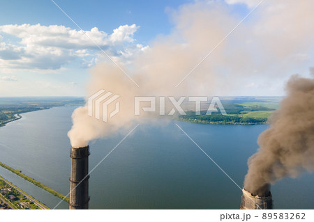 Aerial view of coal power plant high pipes with black smokestack polluting atmosphere. Electricity production with fossil fuel concept. 89583262
