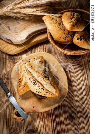Fresh bread rolls on a rustic wooden table. Fresh bread rolls on a rustic wooden table. 89585671