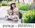 Asian woman playing guitar in the park, lifestyle and recreation concept. Asian woman playing guitar in the park, lifestyle and recreation concept. 89585911