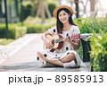 Asian woman playing guitar in the park, lifestyle and recreation concept. Asian woman playing guitar in the park, lifestyle and recreation concept. 89585913