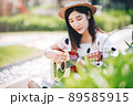 Asian woman playing guitar in the park, lifestyle and recreation concept. Asian woman playing guitar in the park, lifestyle and recreation concept. 89585915