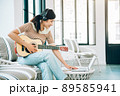 Beautiful Young Asian Woman Playing Guitar and Live Streaming on Social Media at Home While Working from Home in Coronavirus Outbreak Situation , Relax Concept Beautiful Young Asian Woman Playing Guitar and Live Streaming on Social Media at Home While Working from Home in Coronavirus Outbreak Situation , Relax Concept 89585941