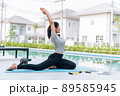 Happy asian woman stretching exercise and yoga workout in the morning at home Happy asian woman stretching exercise and yoga workout in the morning at home 89585945